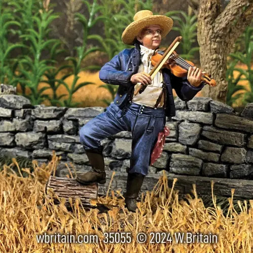 Collectible civilian miniature man with a fiddle. Near a stone wall.