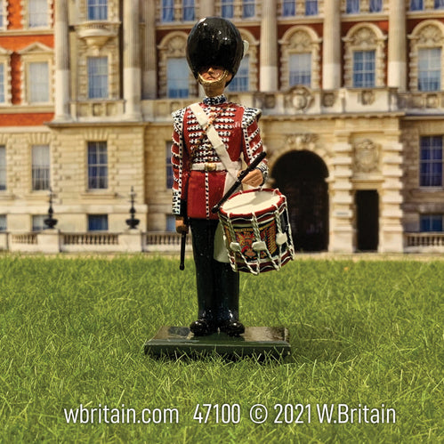 Collectible toy soldier miniature British Grenadier Guards Drummer 1953. He is in front of a palace.