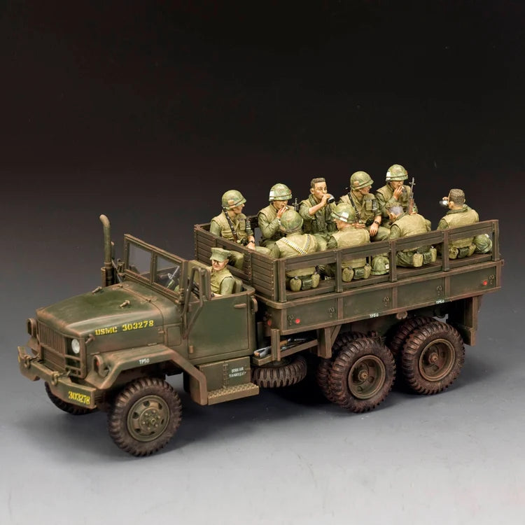 The King &amp; Country model depicts a military transport truck with several toy soldier U.S. Marines.