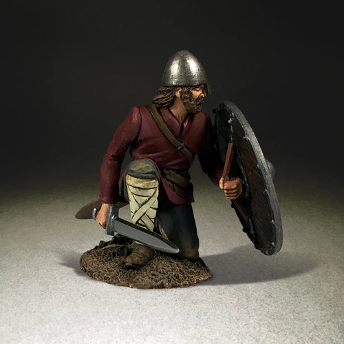 Collectible toy soldier miniature Seaver Saxon Shield Wall Defender. Soldier is kneeling behind shield. Side view.