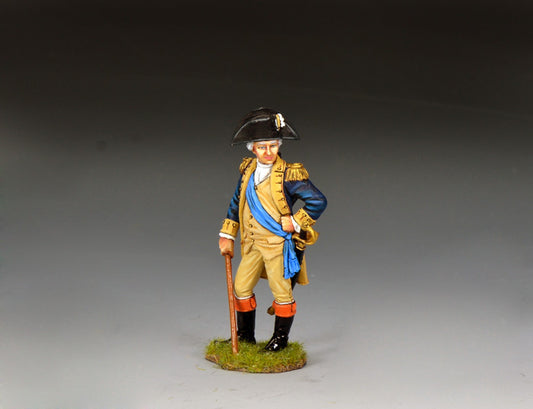 The George Washington toy soldier depicts a man in 18th-century military uniform with a tricorn hat, blue sash, tan coat, and black boots, holding a cane and standing on grass against a gray background.