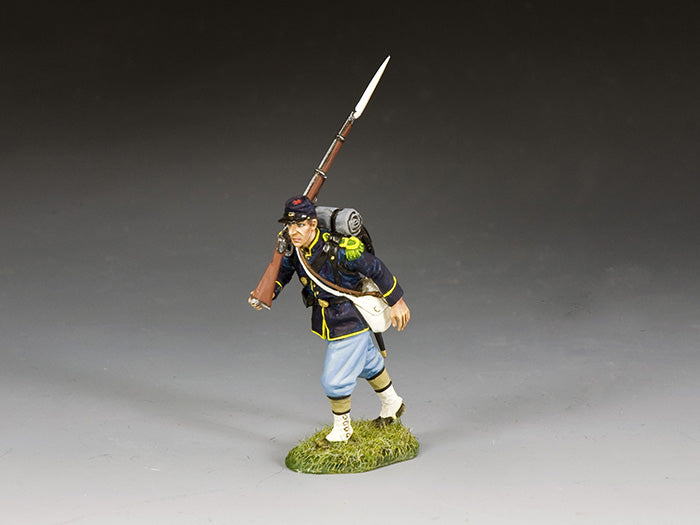 Union infantryman marches with rifle slung on shoulder, wearing full gear and dark blue frock coat with sky blue trousers.