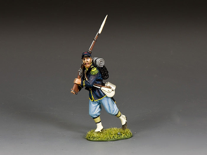 Union infantryman toy soldier in dark blue coat advances with rifle and bayonet ready, gripping weapon with both hands mid-charge.
