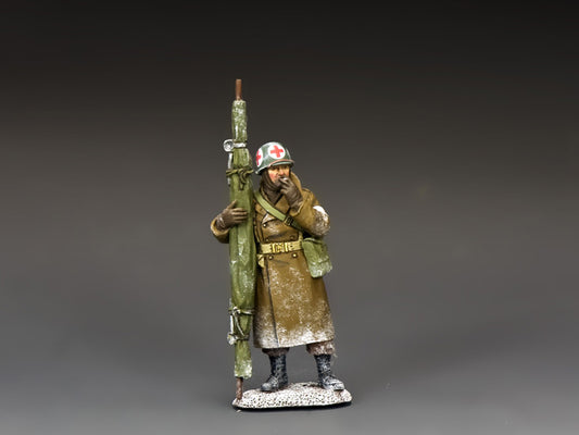 WWII U.S. Army medic in snow gear with stretcher and Red Cross helmet, taking a smoke break during the Battle of the Bulge. 1/30 scale.