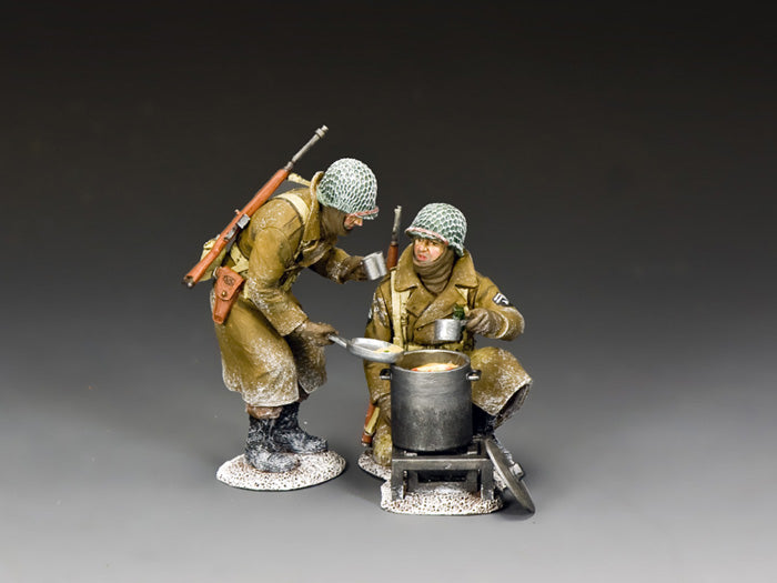 Two WWII GIs in winter gear share hot stew from a field cooker during the Battle of the Bulge. 1/30 scale hand-painted figures.
