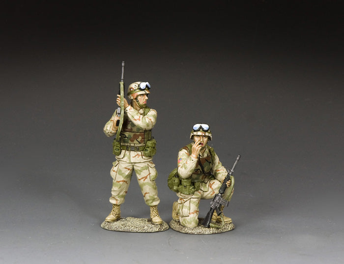 Two toy soldier U.S. Army Rangers in desert camo—one kneels on radio, the other stands guard with rifle.