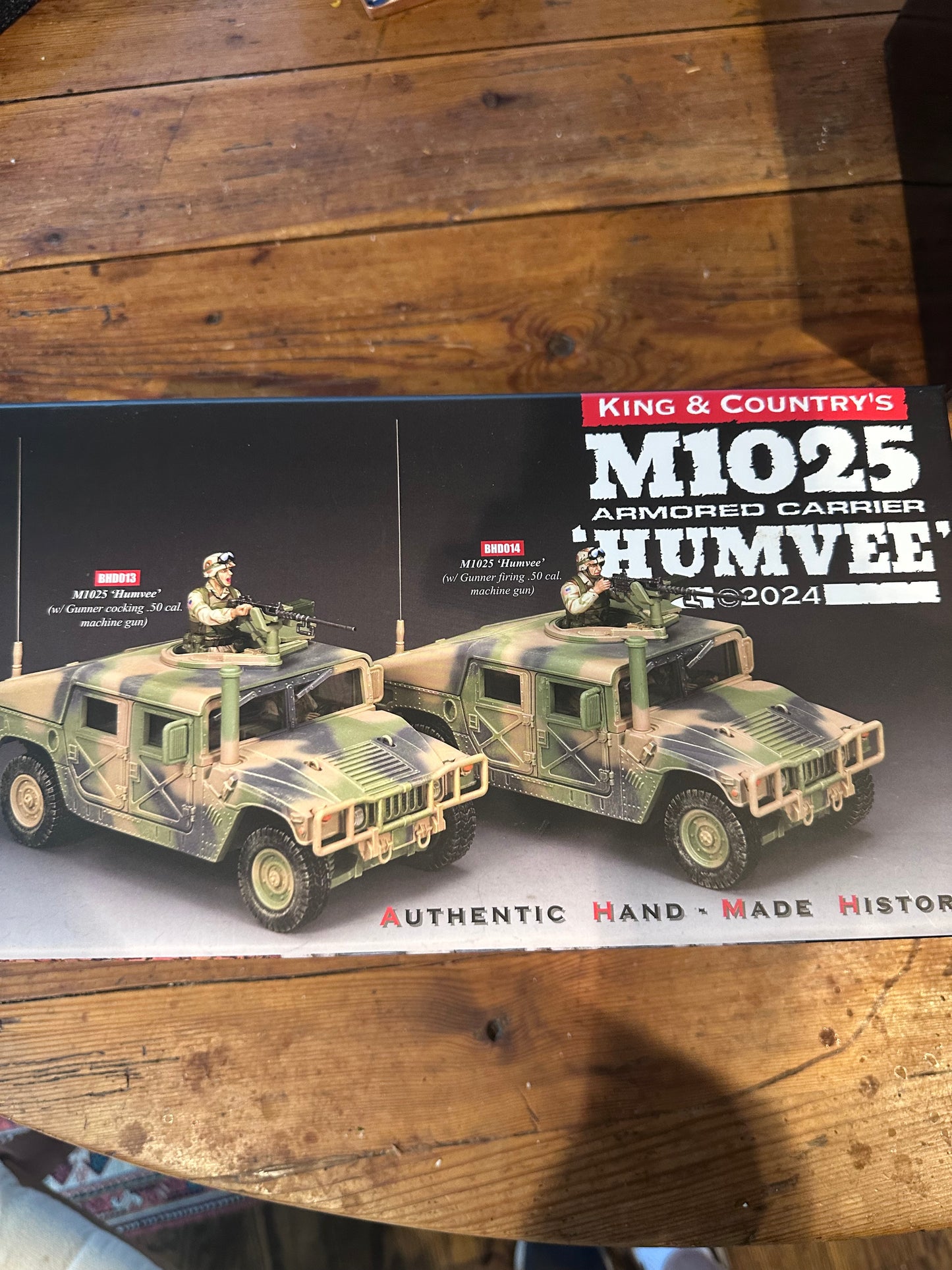 Model of a military vehicle on a display card with branding text