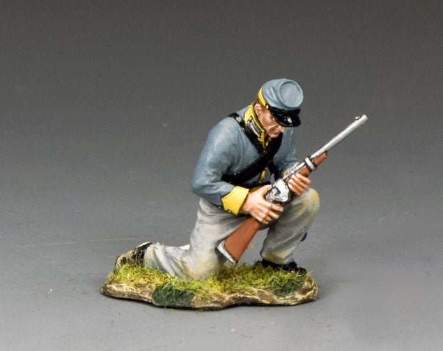 Military miniature of a kneeling Confederate trooper cocking a carbine, dressed in gray and yellow uniform, ready to fire.