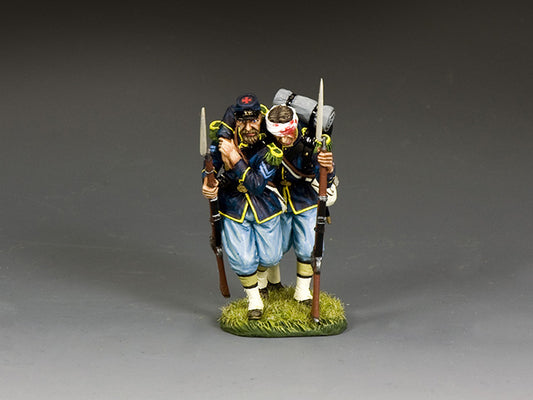 Union corporal supports a wounded comrade with bandaged head, both armed and in full gear, advancing toward aid.