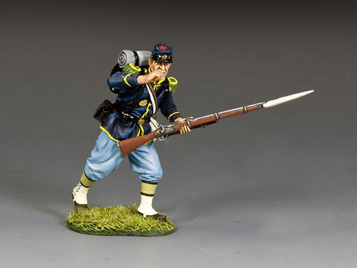 Union infantryman bites open paper cartridge, preparing to load muzzleloader during the heat of Civil War battle.