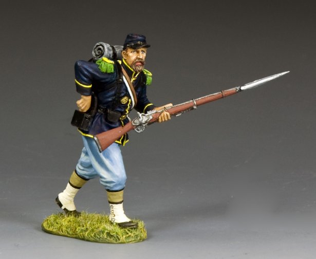 Union infantryman toy soldier reaches for a cartridge from his rear pouch while holding bayoneted rifle during reloading in Civil War battle.