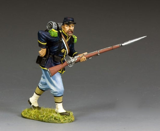 Union infantryman toy soldier reaches for a cartridge from his rear pouch while holding bayoneted rifle during reloading in Civil War battle.