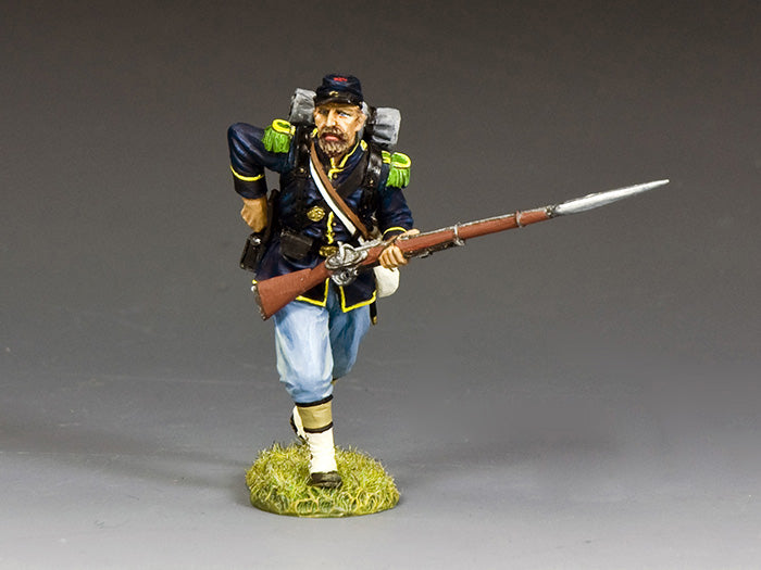 Union infantryman toy soldier reaches for a cartridge from his rear pouch while holding bayoneted rifle during reloading in Civil War battle.