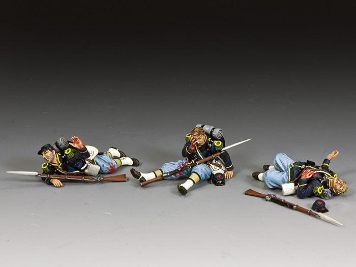 Three fallen Union toy soldiers  shown wounded or dead, representing Civil War battlefield casualties.