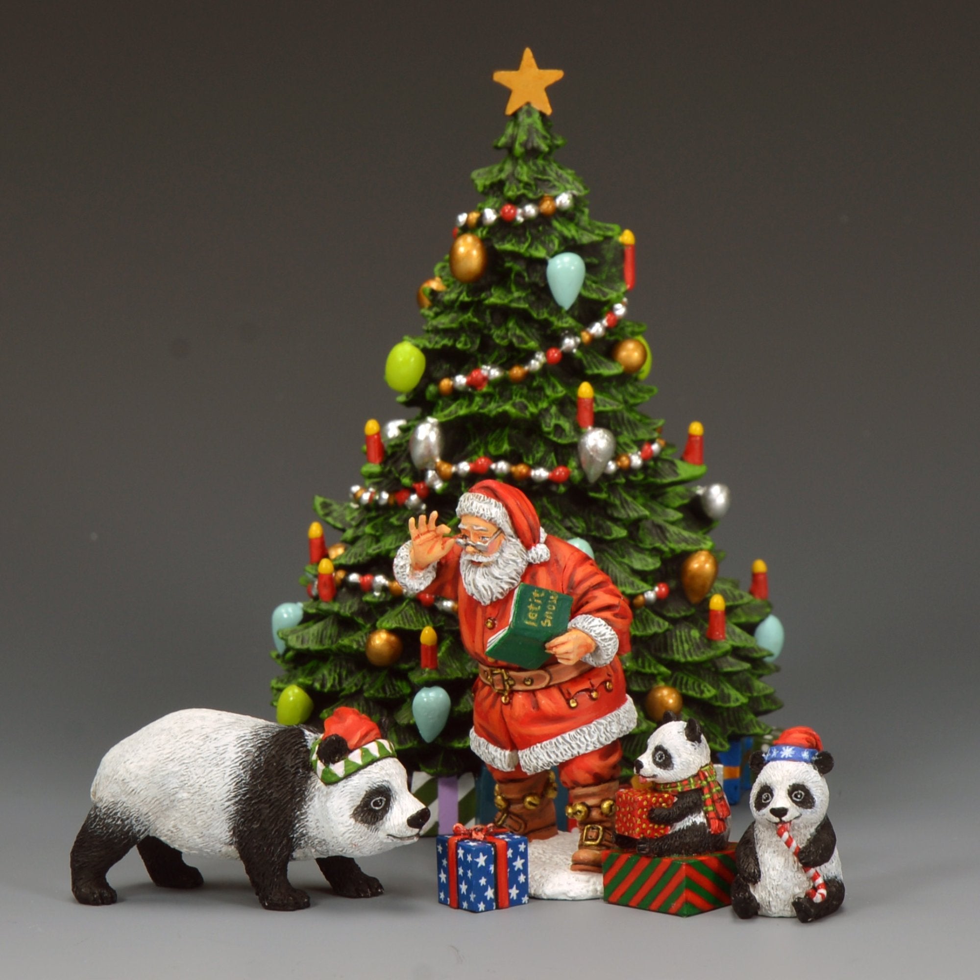 Decorative scene with Santa Claus, panda bears, and a Christmas tree on a gray background