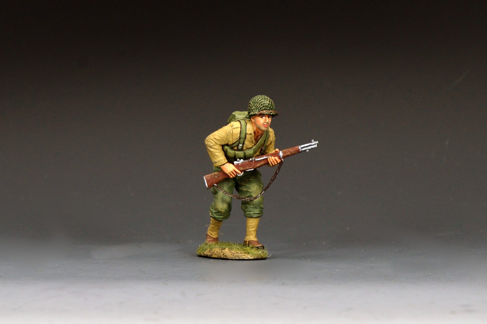 King & Country DD400 figure of a U.S. Army rifleman advancing at a crouch with an M1 Garand held ready, net-covered helmet and field pack.