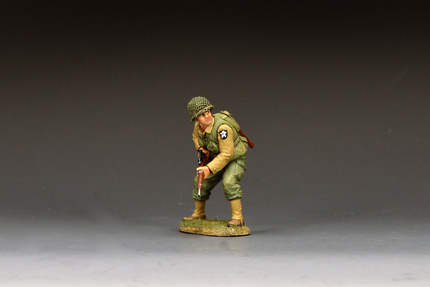 King & Country DD403 figure of a U.S. Army sniper of the 2nd Infantry Division crouching forward with a scoped M1903A4 Springfield rifle, net-covered helmet and Indian Head patch.