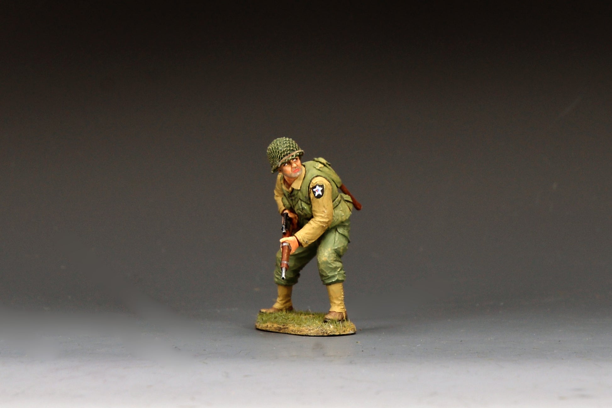 King & Country DD403 figure of a U.S. Army sniper of the 2nd Infantry Division crouching forward with a scoped M1903A4 Springfield rifle, net-covered helmet and Indian Head patch.