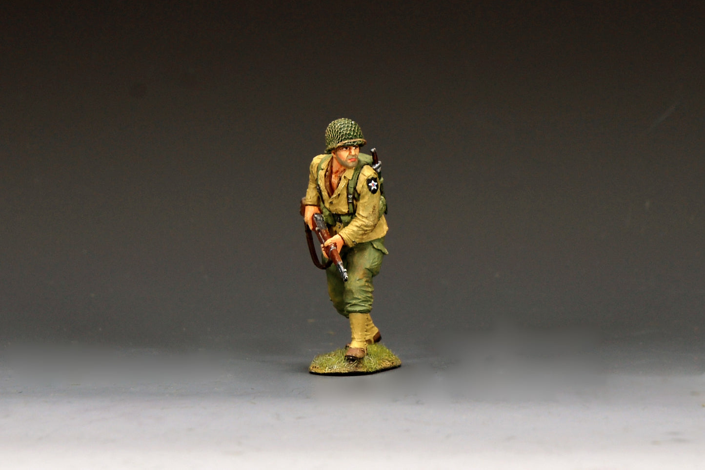 King & Country DD404 figure of a U.S. Army scout advancing warily at the front with an M1 Garand held low, net-covered helmet, pack and Indian Head patch.