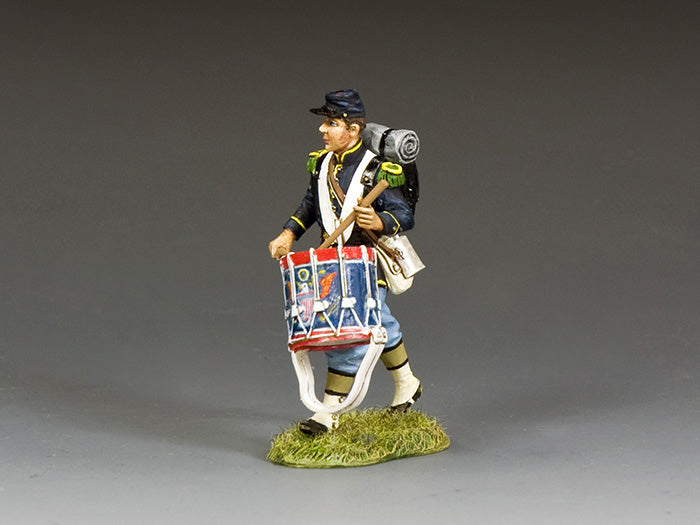 Union Civil War drummer boy marches forward, beating a steady rhythm to rally troops, dressed in full uniform with field gear.