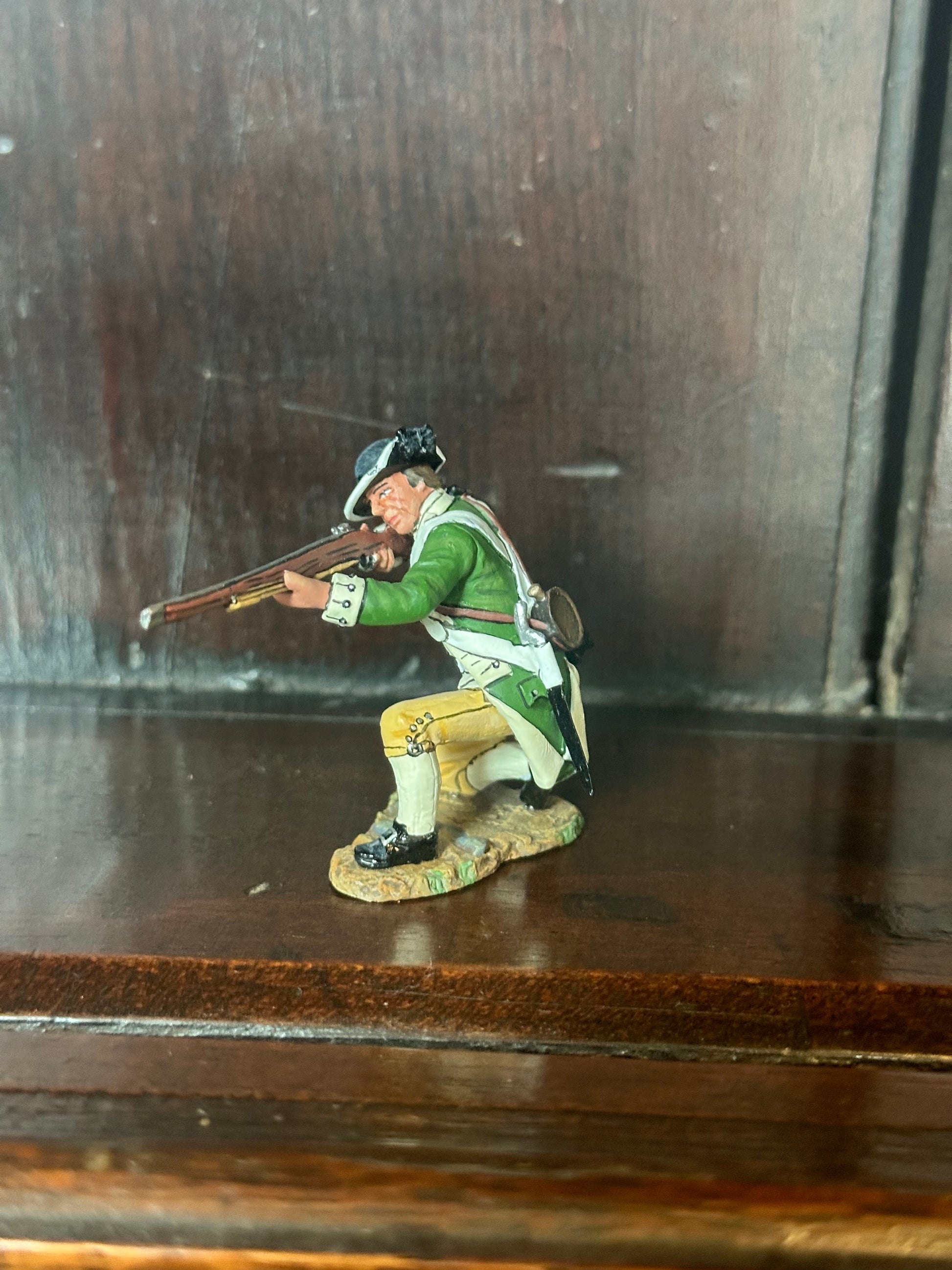 Collectible toy soldier miniature army men Kneeling Firing. Displayed on a shelf.