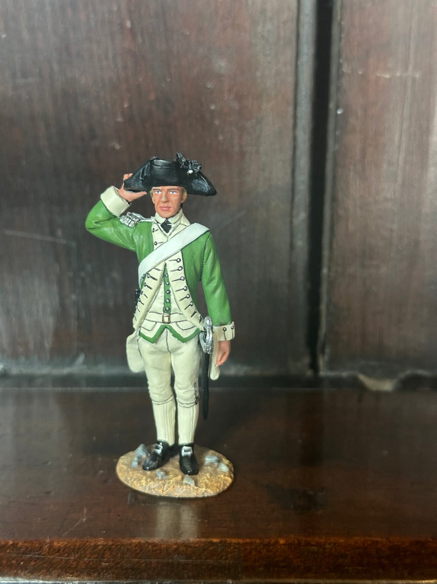 Collectible toy soldier miniature army men Marine Officer Saluting. Displayed on a shelf.