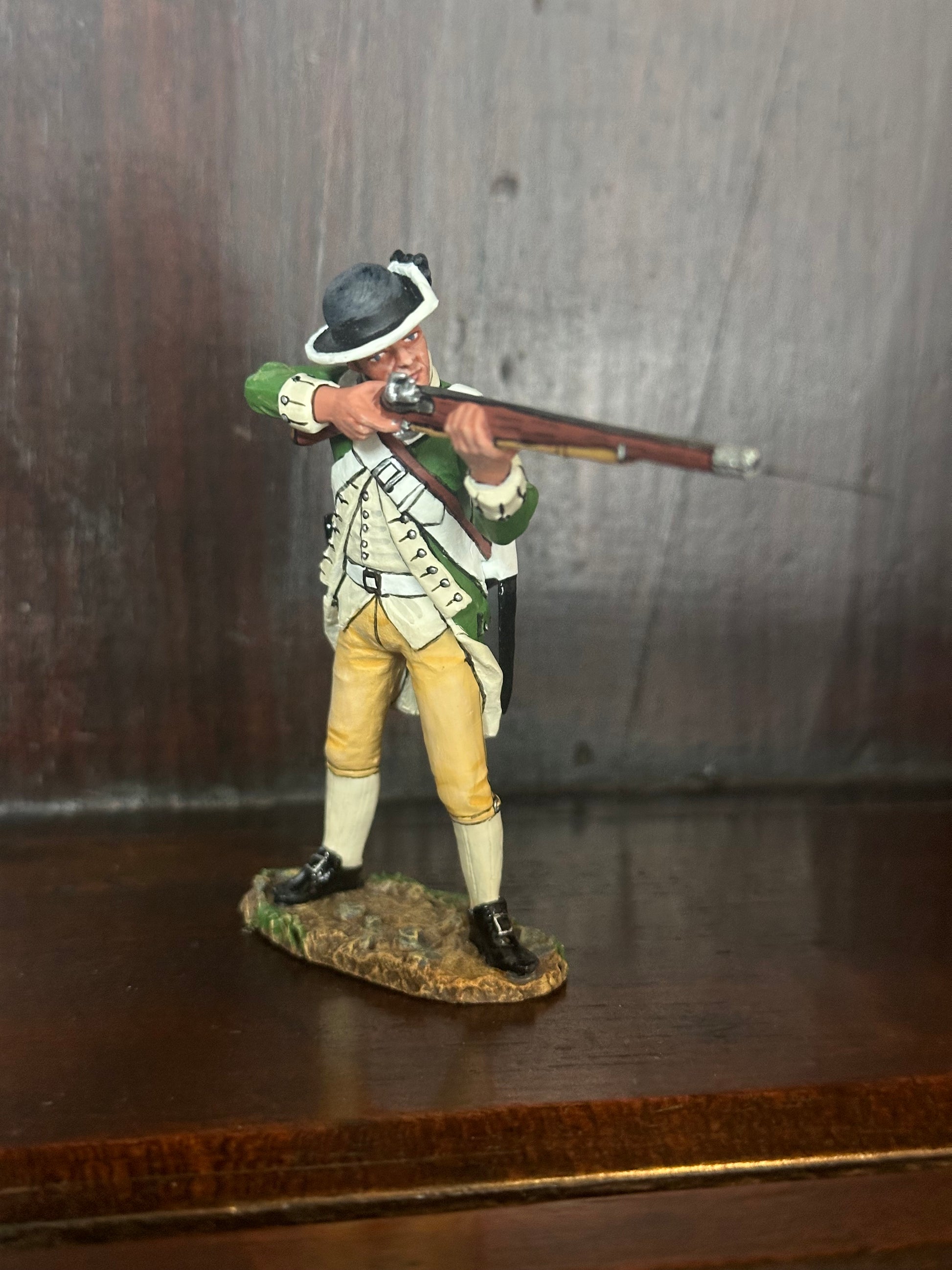 Collectible toy soldier miniature army men Standing Firing Marine. Displayed on a shelf.
