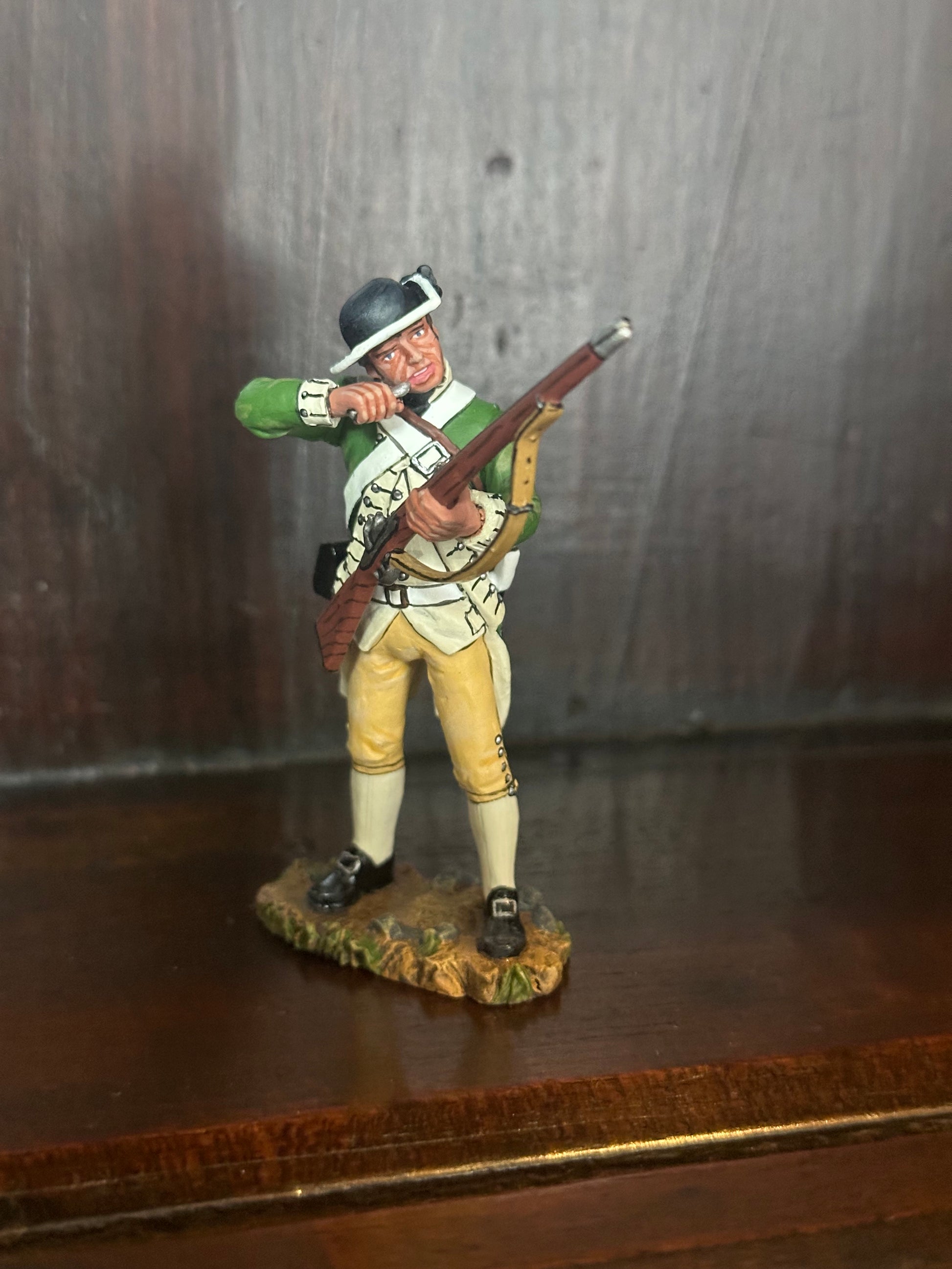 Collectible toy soldier miniature army men Standing Loading Corporal. Displayed on a shelf.