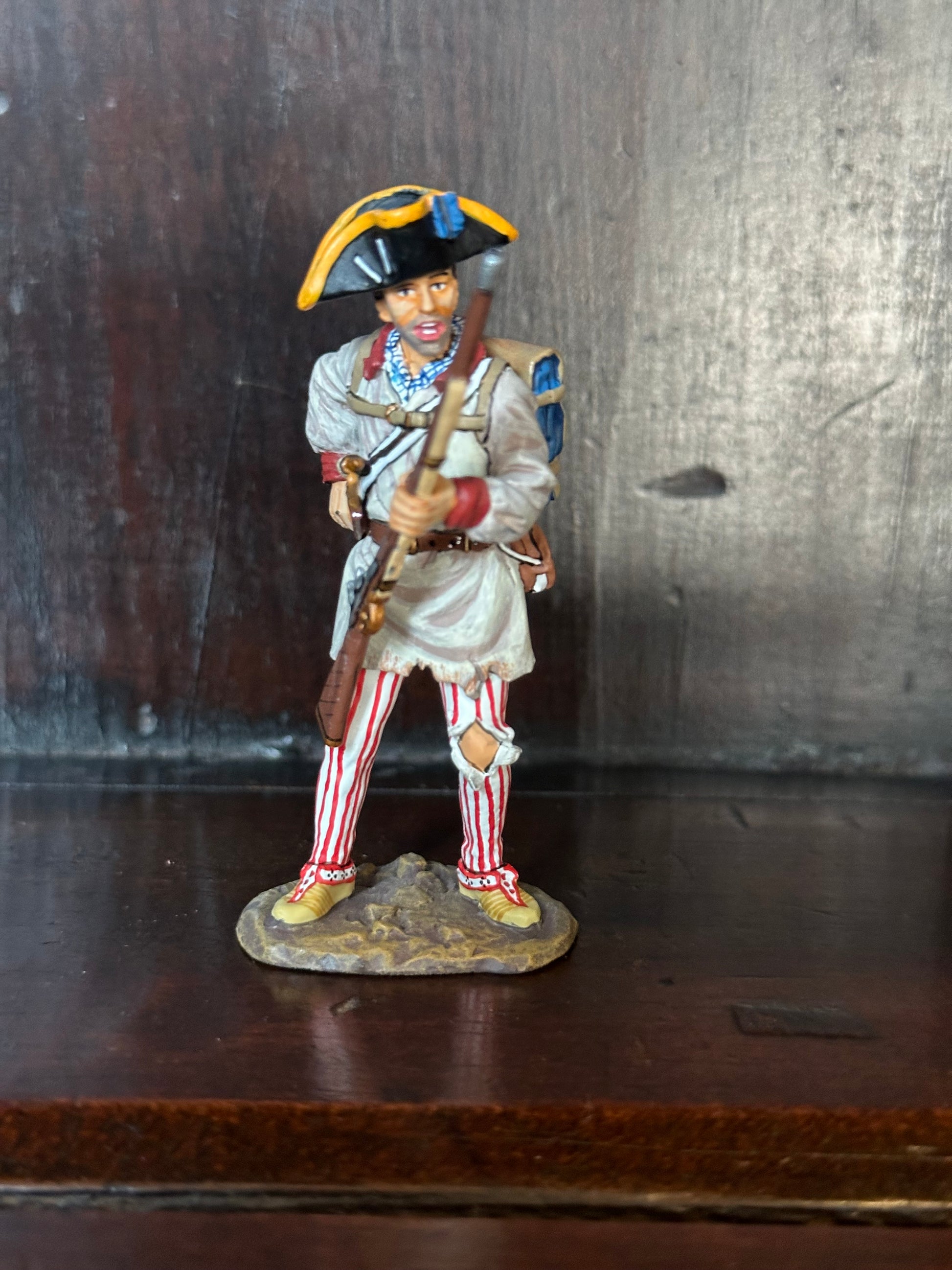 Collectible toy soldier miniature army men Rifleman Holding Cartridge. Displayed on a shelf.
