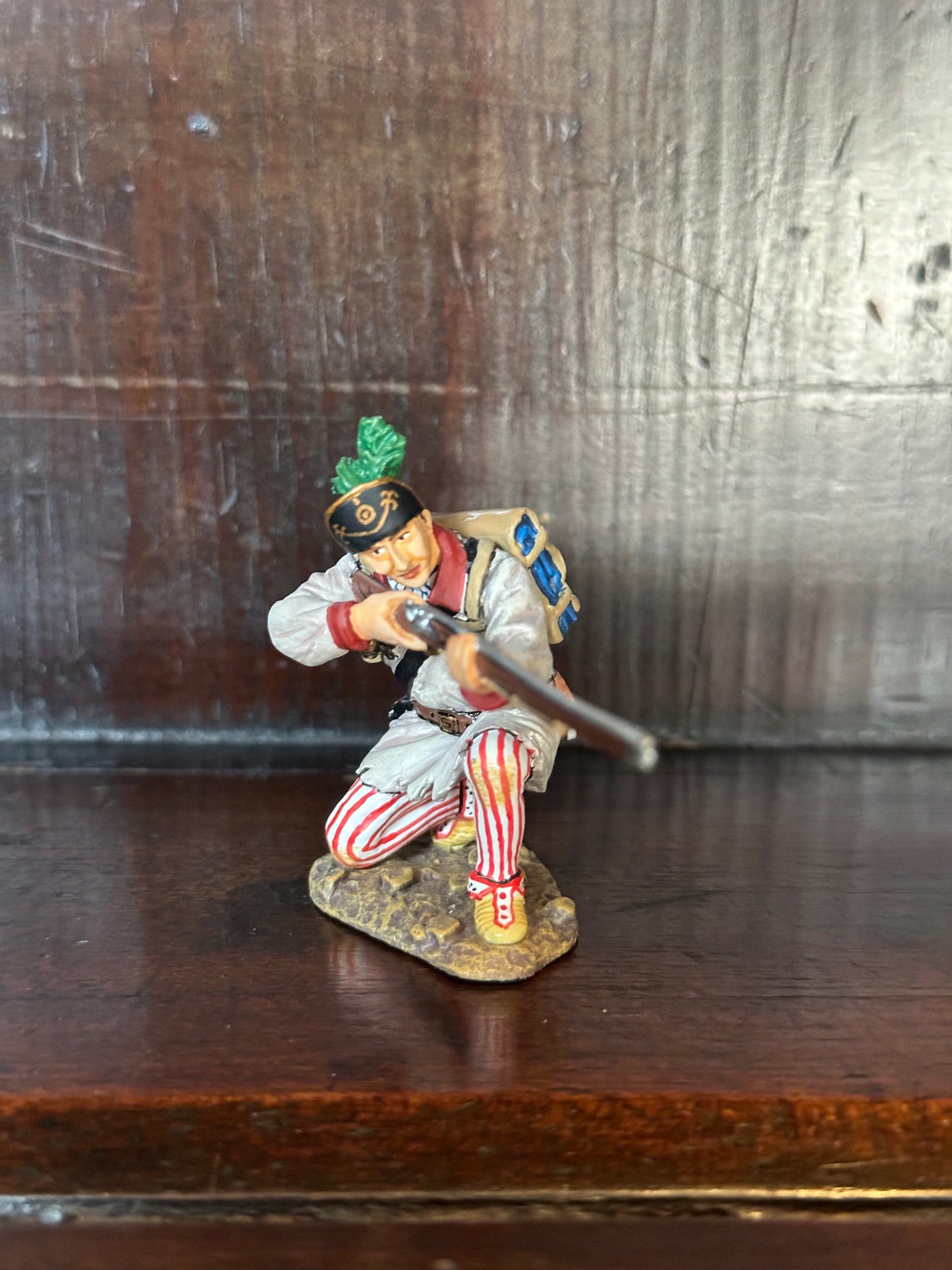 Collectible toy soldier miniature army men Kneeling Militiamen Firing. He has red stripes.