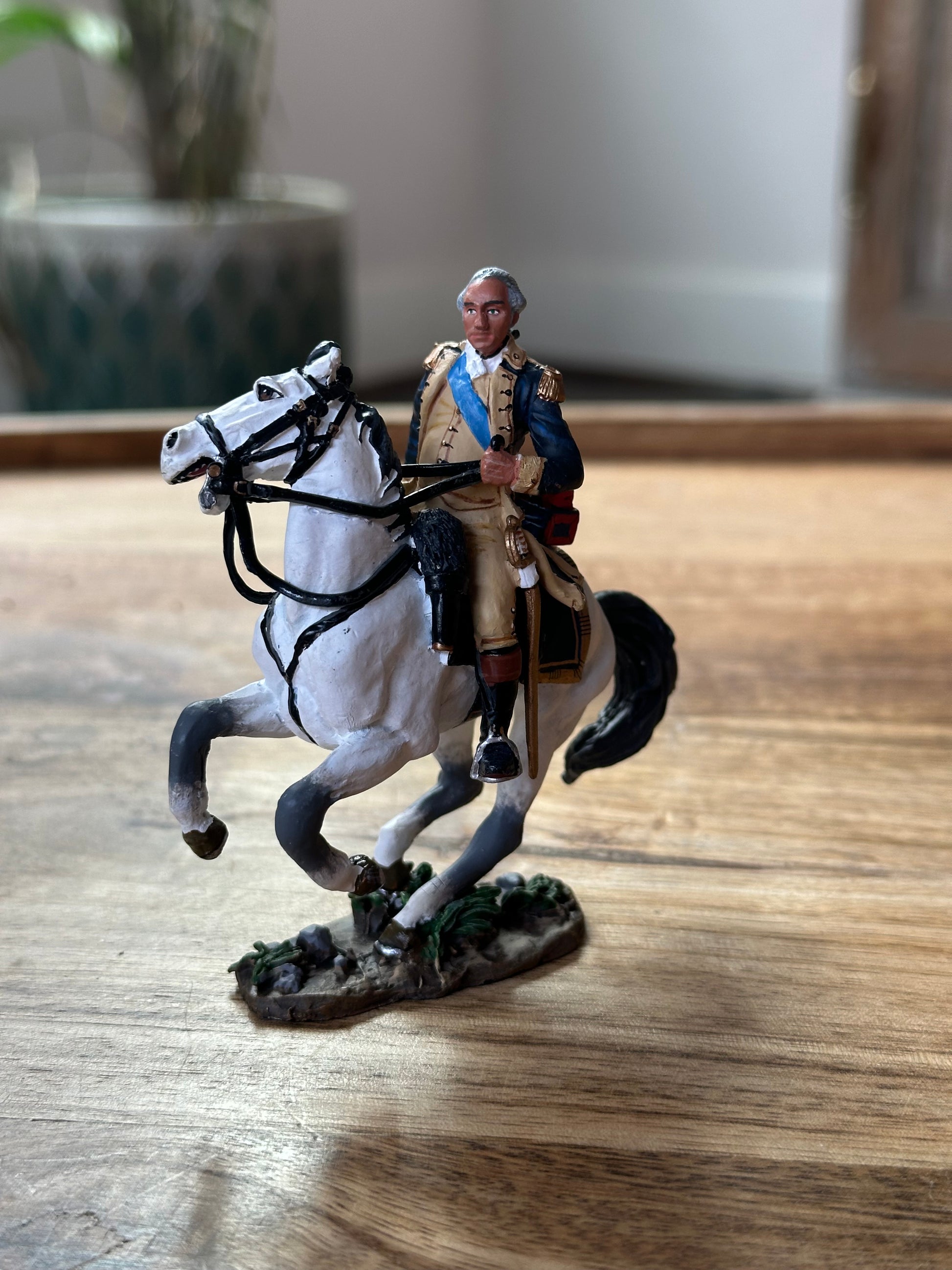 Collectible toy soldier miniature army men George Washington on Horseback. Displayed on a table.