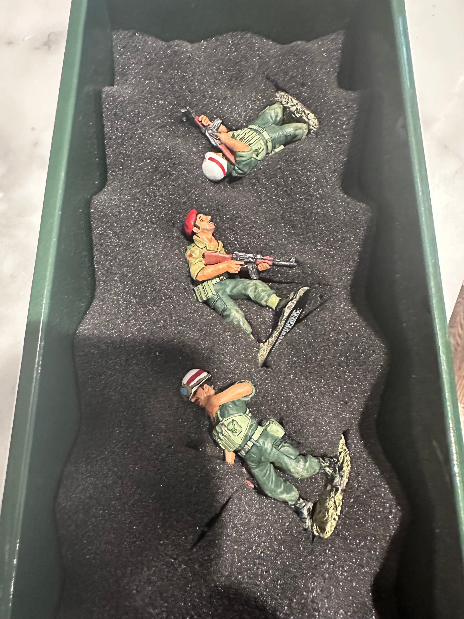 Collectible toy soldier miniature army men seen in the packaging box.
