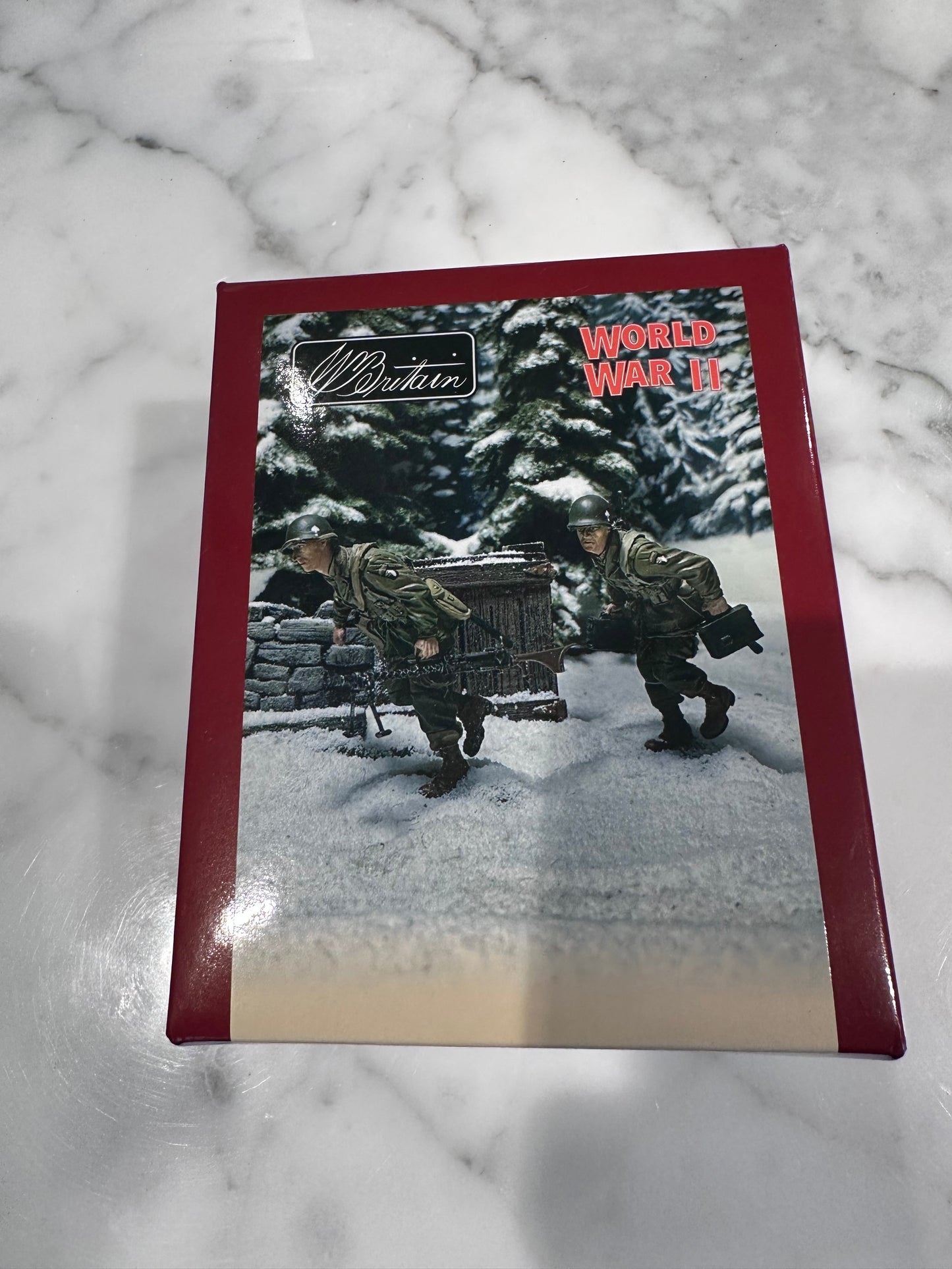 World War II-themed packaging with a soldier and tank illustration on a marble surface