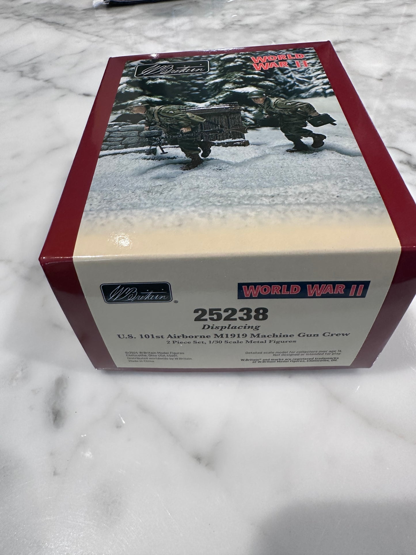 Model kit box with 'World War II' theme on a marble surface
