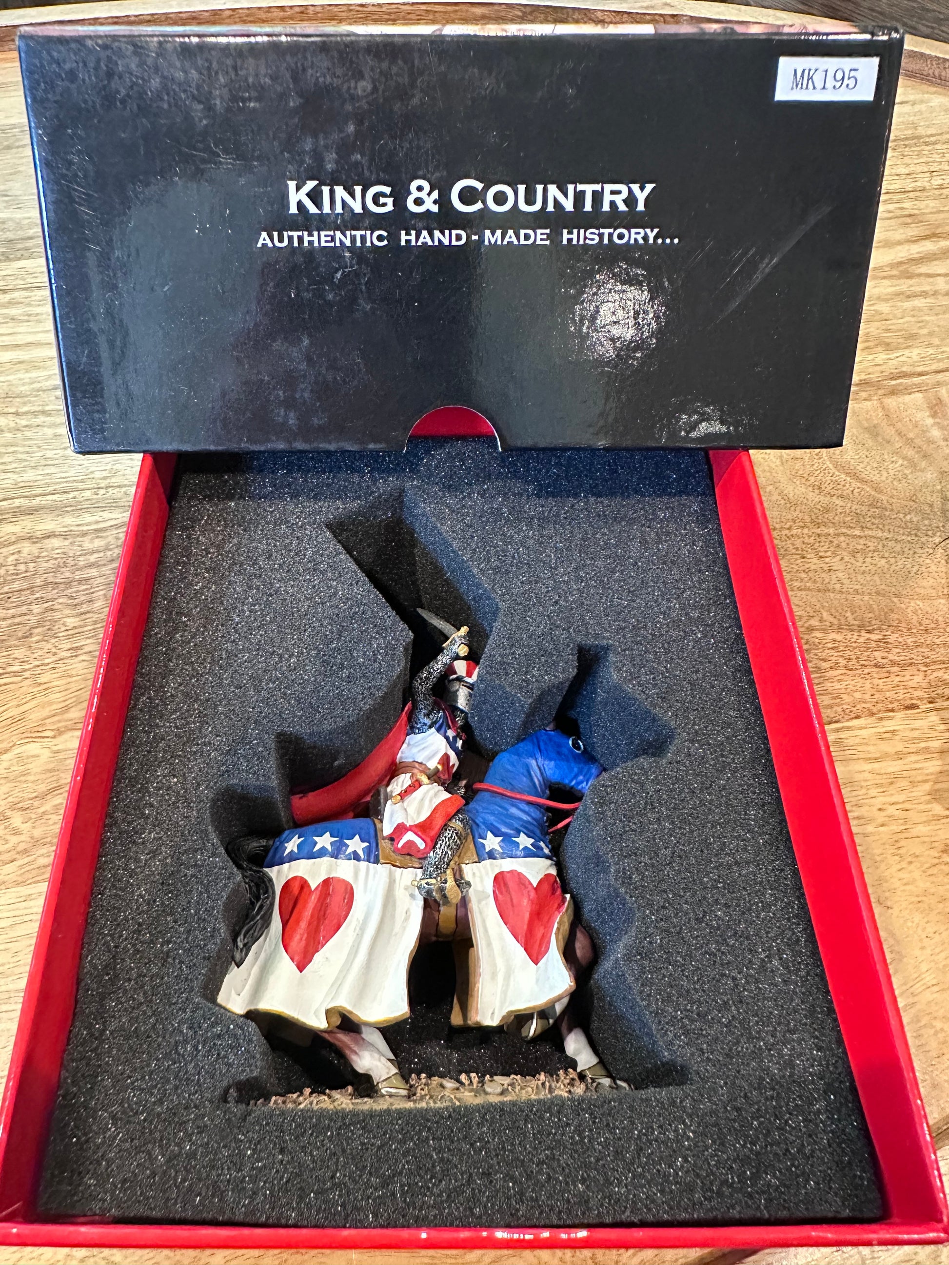 Decorative toy soldier Sir Archibald Douglas in a box with 'King & Country' branding on a wooden surface.