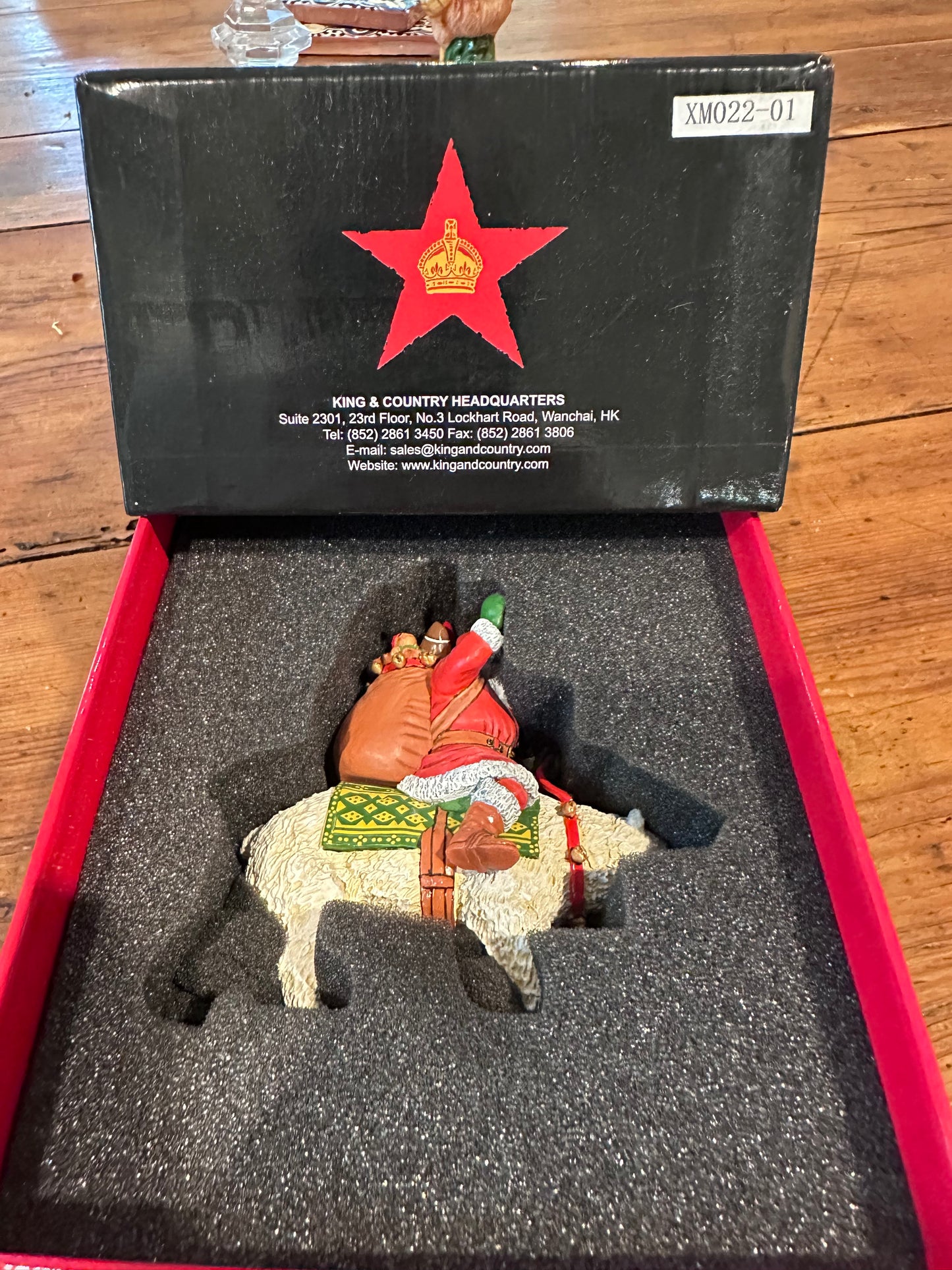 Decorative Christmas ornament in a box with a visible brand logo.