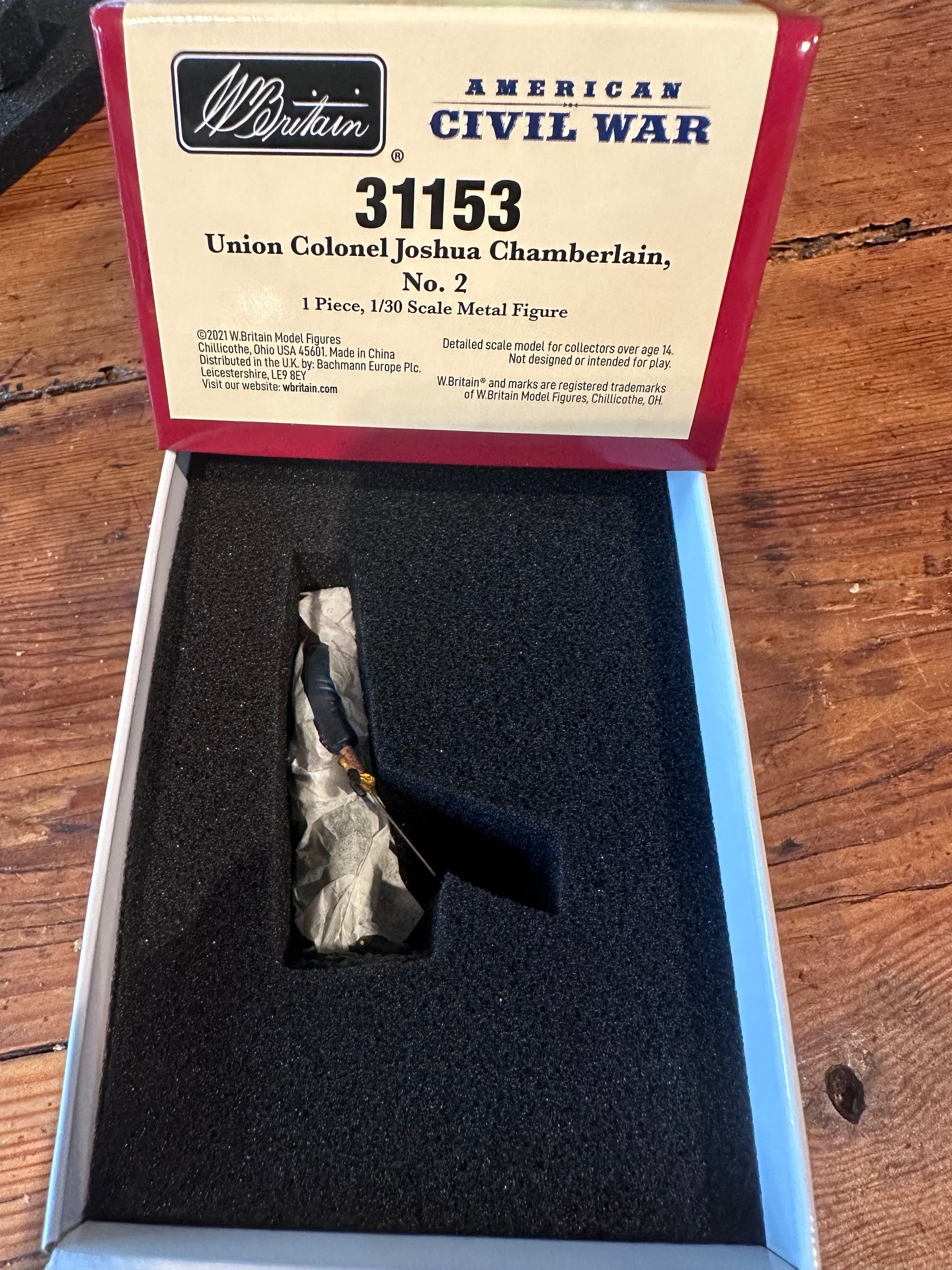 Boxed Union Colonel Joshua Chamberlain figure with label on a wooden surface