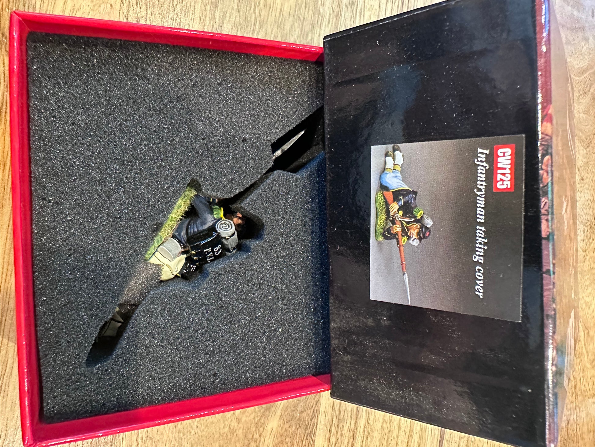 Lying Ready presented in a classic red collector's box.