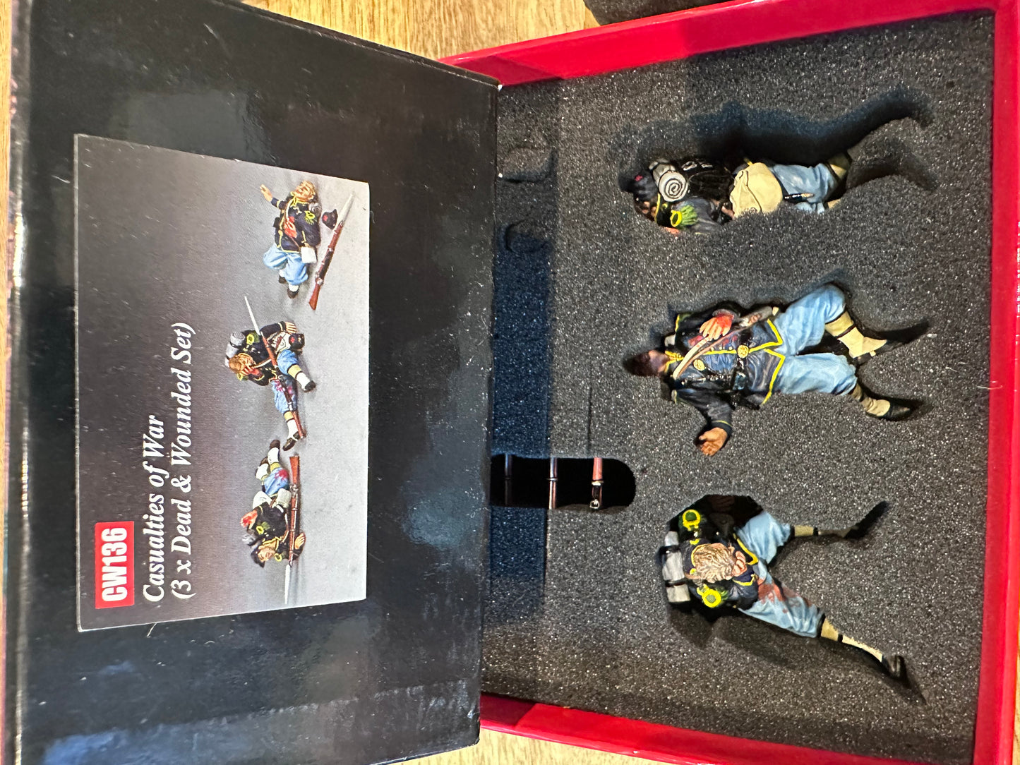 Casualties of War presented in a classic red collector's box.