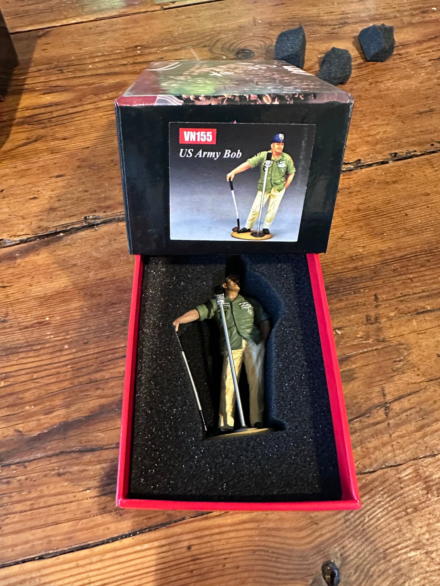 US Army Bob figurine in a red box on a wooden surface