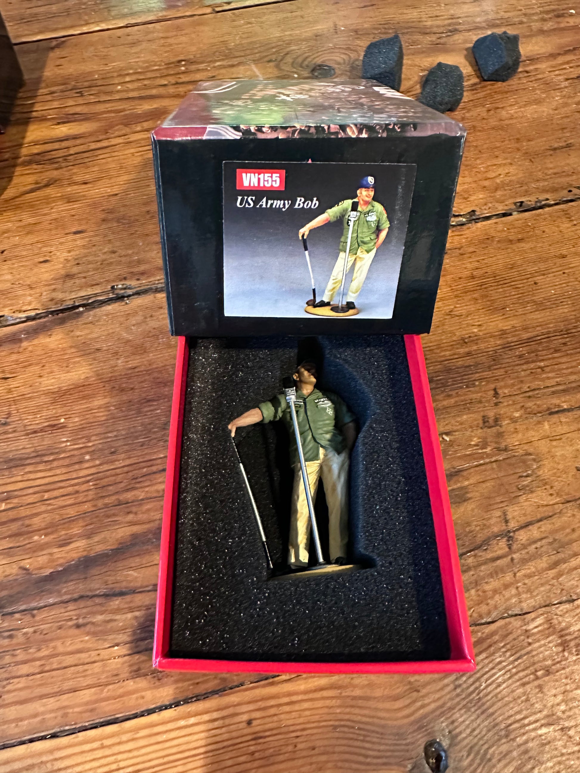 US Army Bob figurine in a red box on a wooden surface