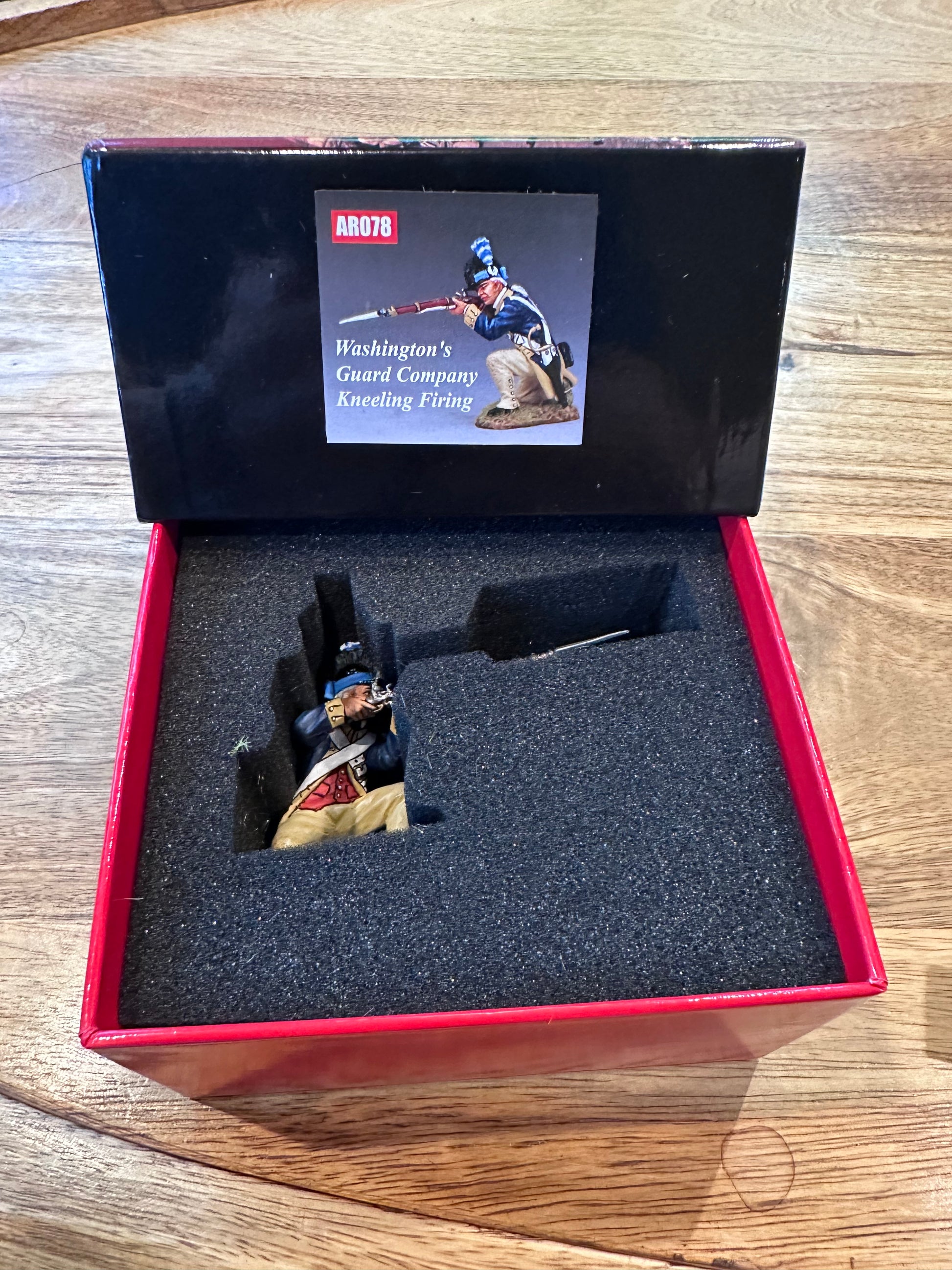 Washington's Guard Company Kneeling Firing presented in a classic red collectors box.