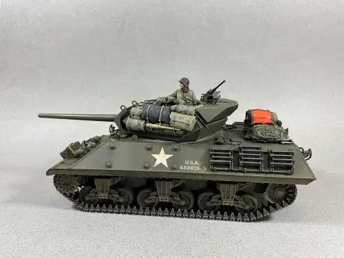 Model tank with a soldier figure on a white background