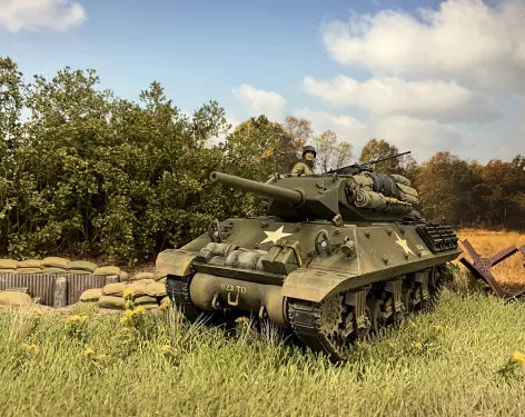 Tank in a grassy field with trees in the background