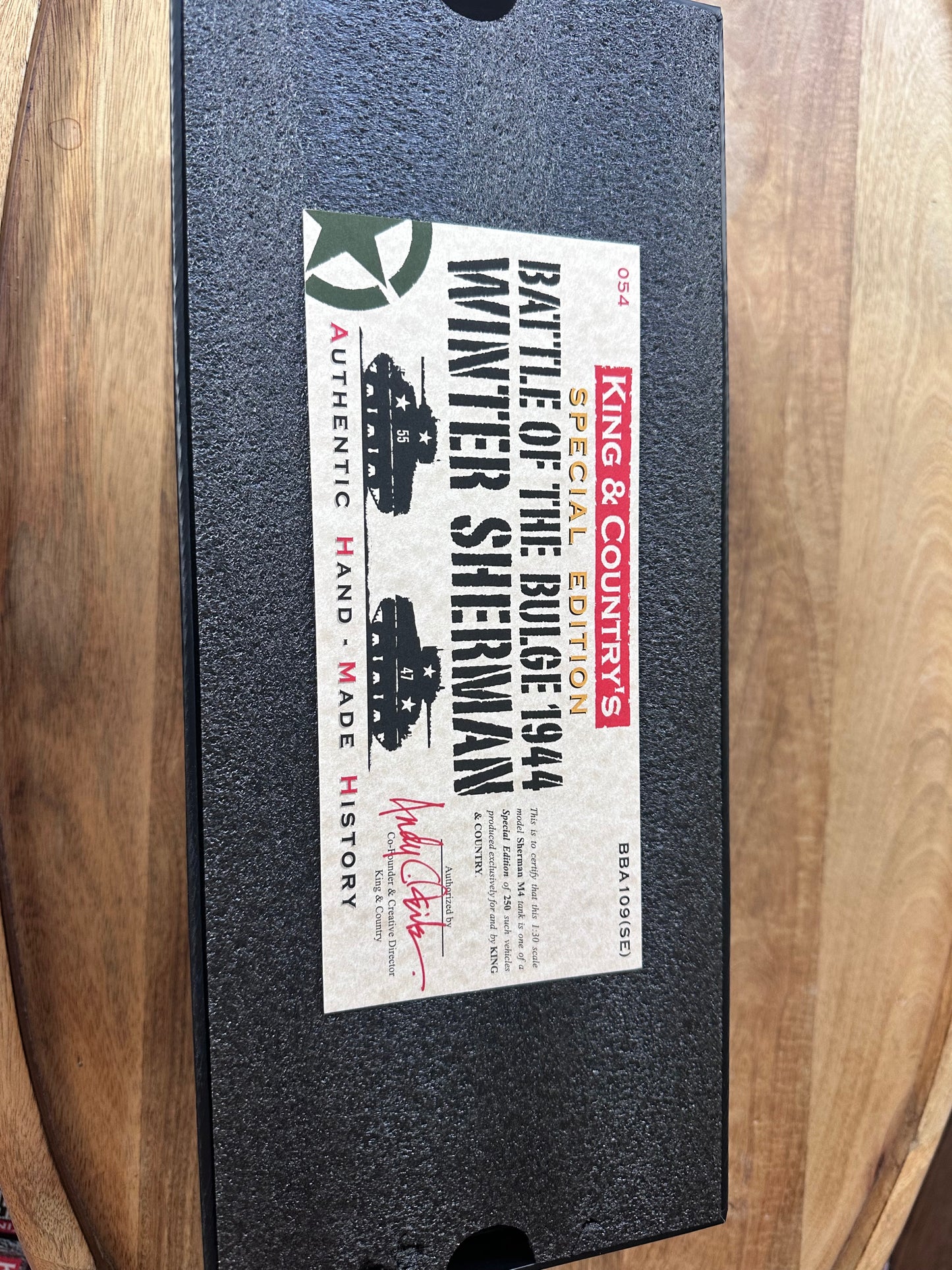 Box for King & Country's Battle of the Bulge 1944 Winter Sherman model on a wooden surface
