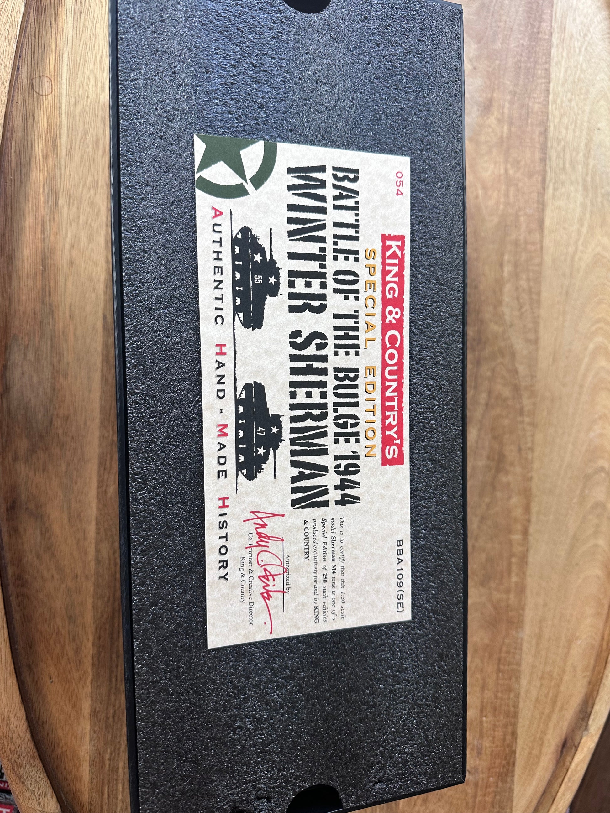 Box for King & Country's Battle of the Bulge 1944 Winter Sherman model on a wooden surface