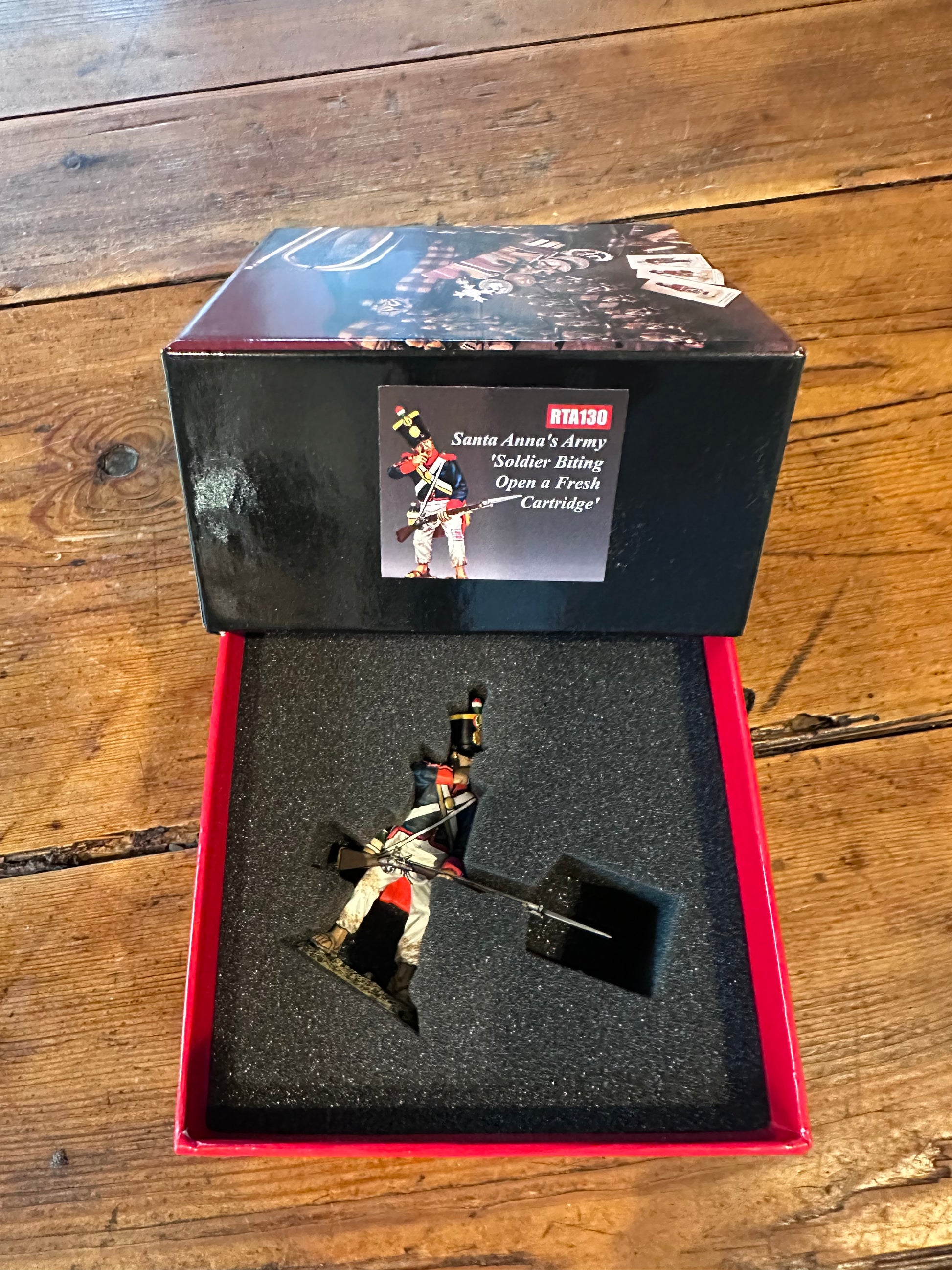Santa Anna's Soldier Biting Open a Fresh Cartridge military miniature packaged in a classic red collector box