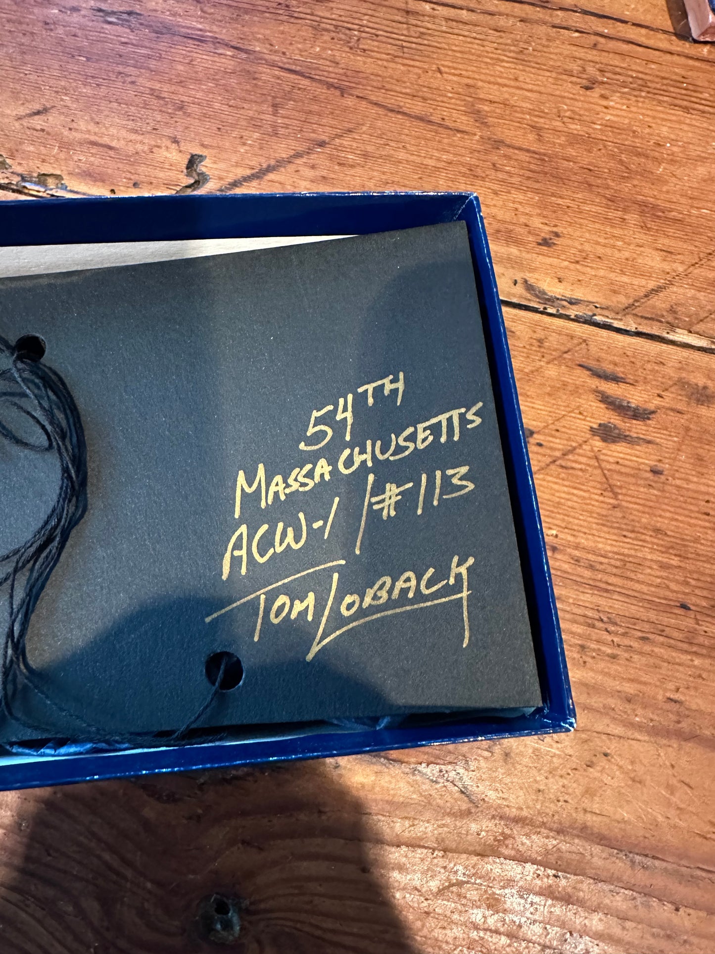 Thomas Loback signature and edition number 113 on the inside of the 54th Massachusetts box