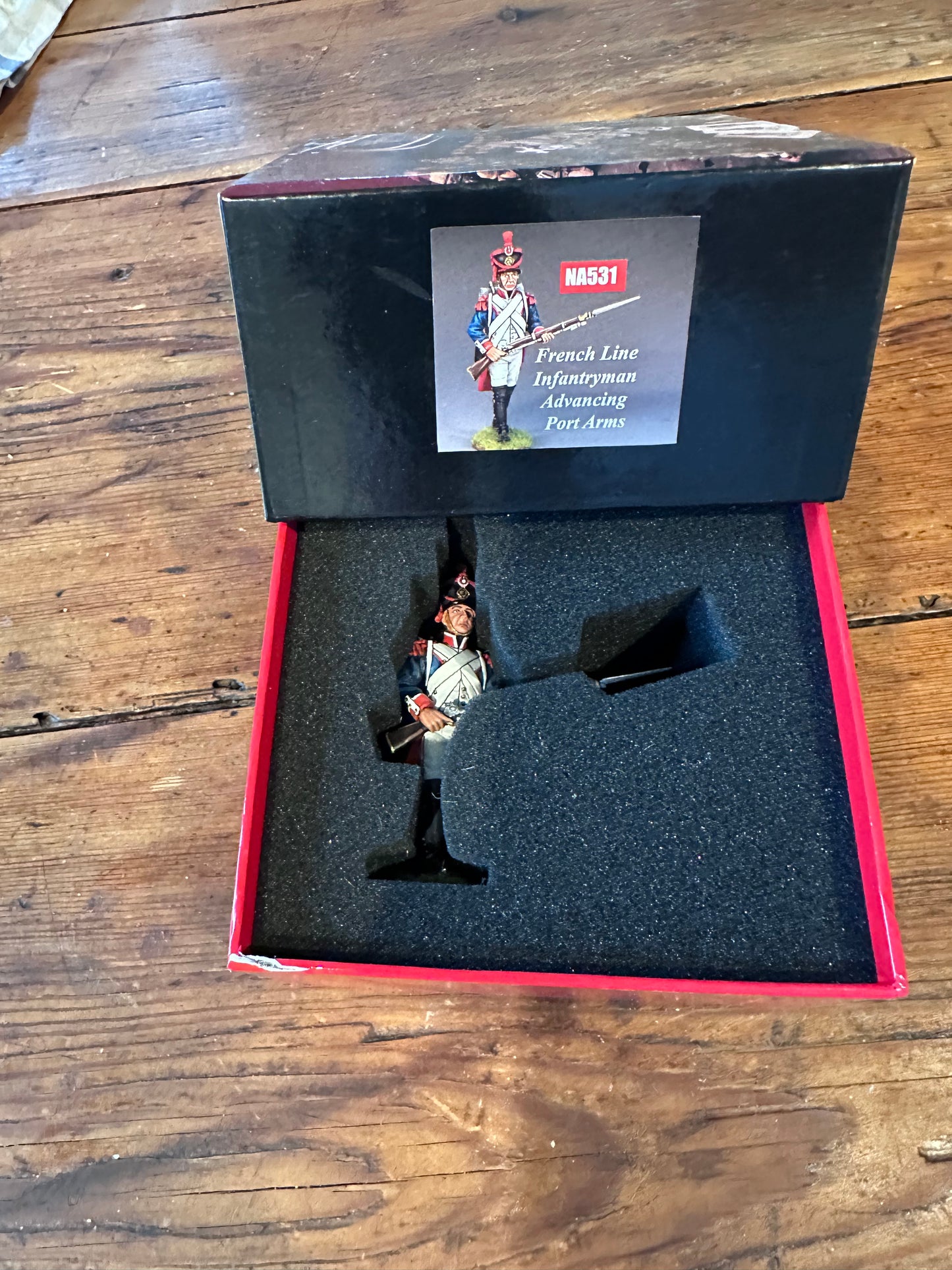 NA531 FLI Advancing Port Arms packaged in a classic red collector box.