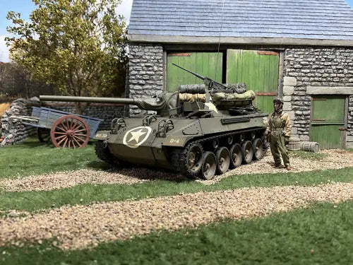 Collectible toy soldier tank in a field with toy soldier.